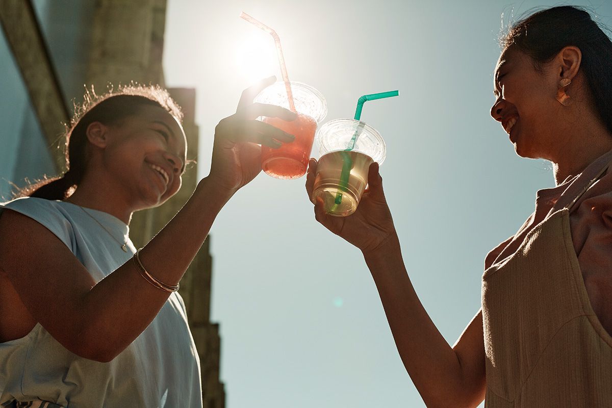 Two women drinking alcohol outside in New Orleans.