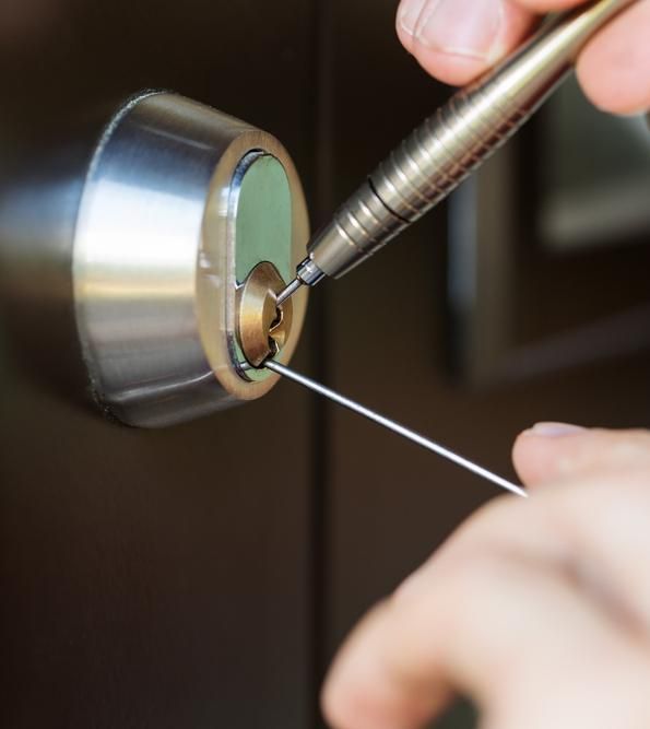 A Person is Using a Pen to Open a Door Lock — FNQ Locksmiths In Mossman, QLD