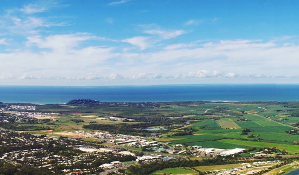 An Aerial View of a City Surrounded by Fields and a Body of Water — FNQ Locksmiths In Smithfield, QLD