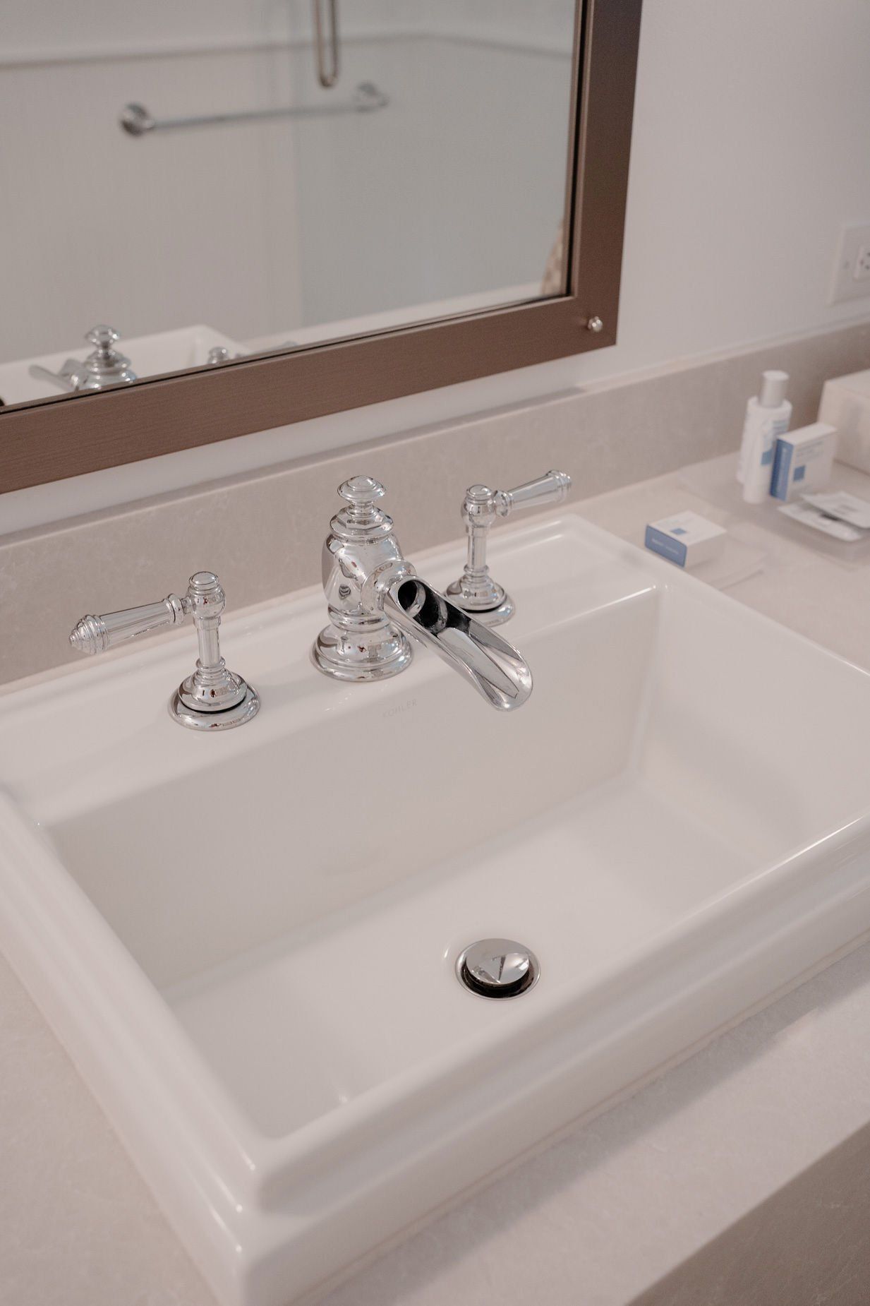 A bathroom sink with a mirror behind it