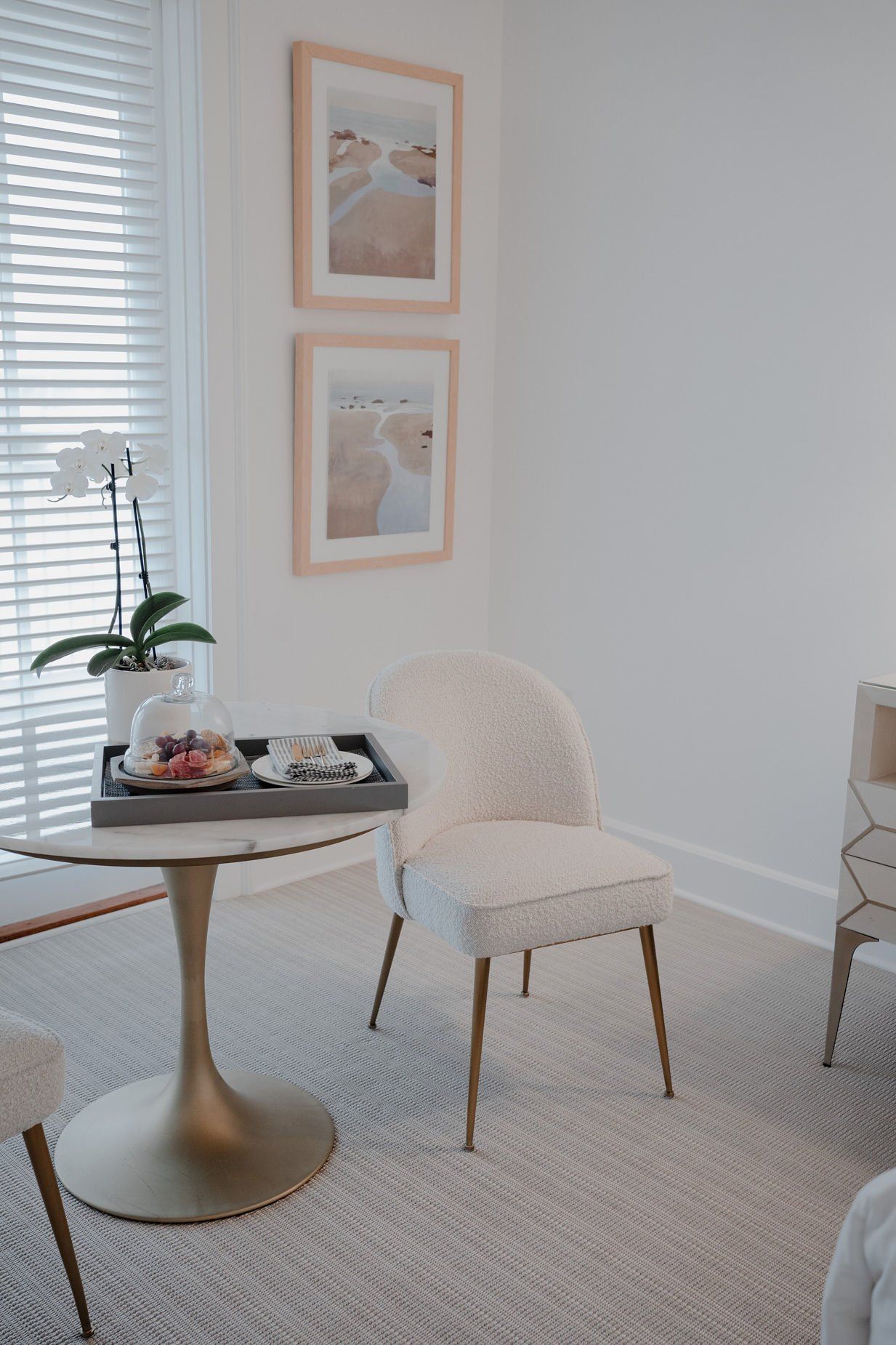 A room with a chair and a table with a tray of hors d'oeuvres on it