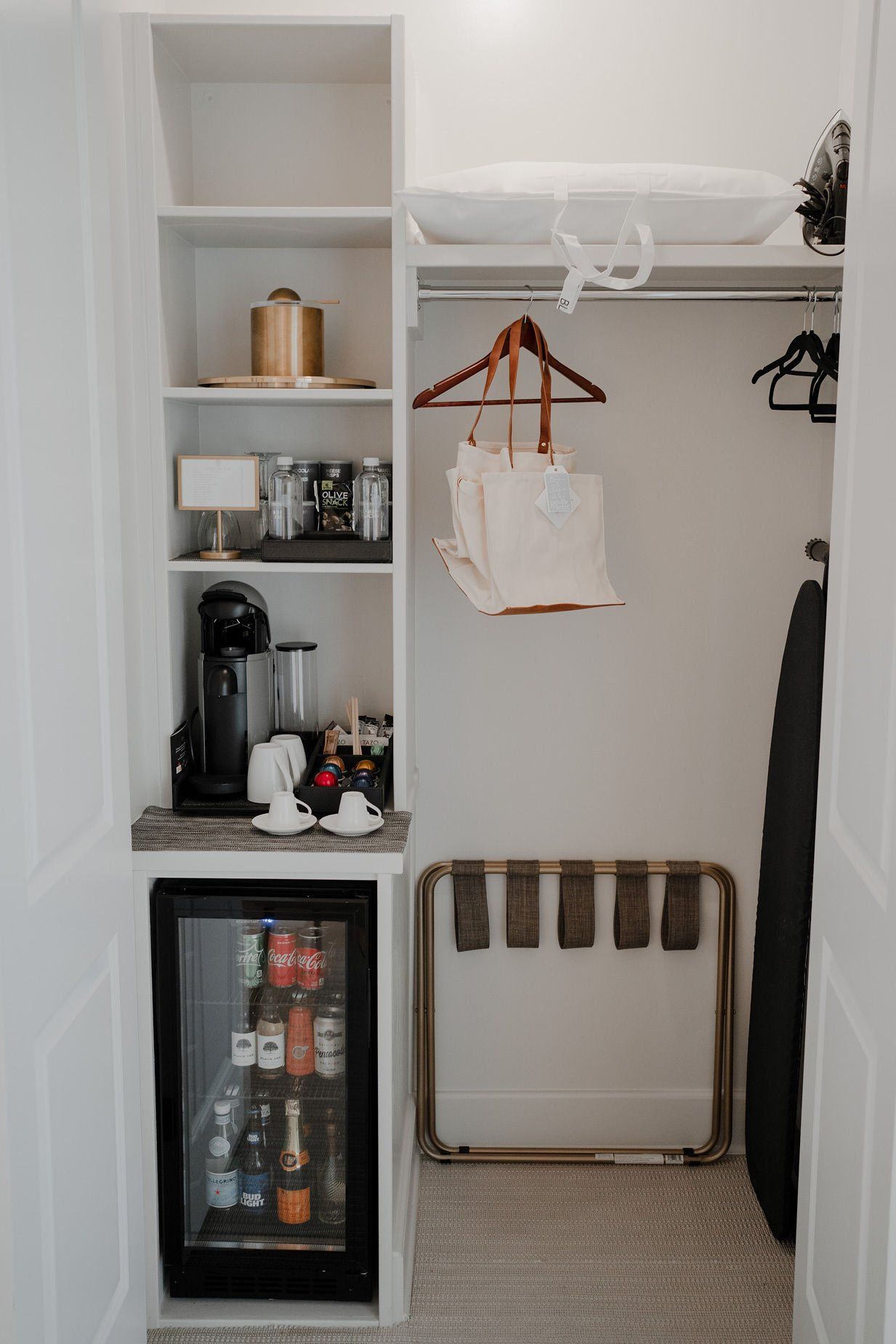 A closet with a mini fridge filled with drinks