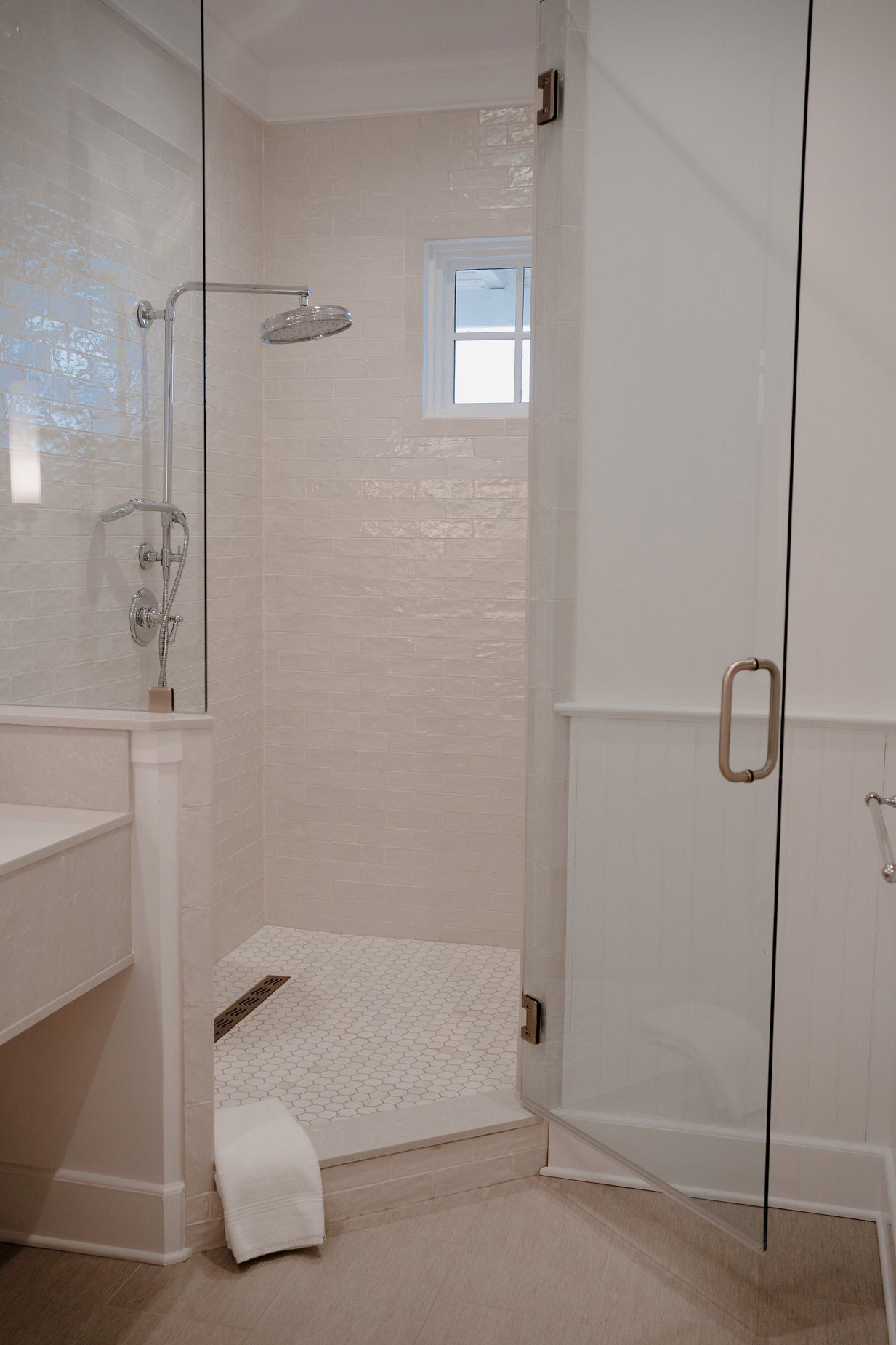 A bathroom with a walk in shower and a sink