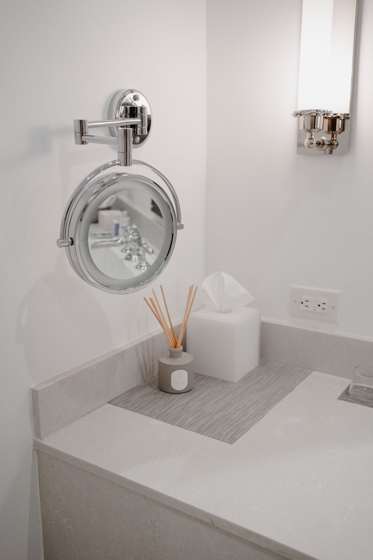 A bathroom with a mirror and a tissue box on the counter