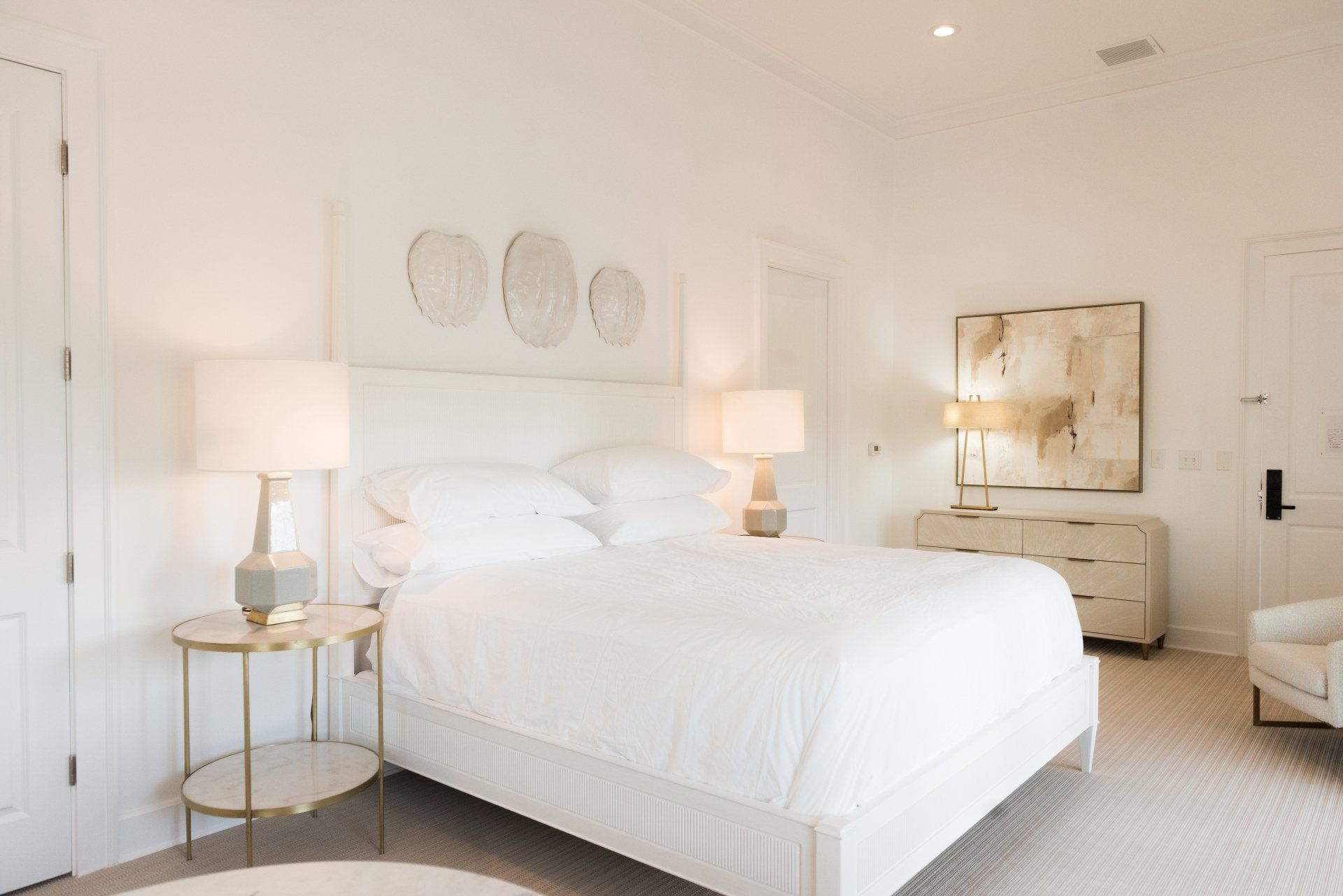 A bedroom with a king size bed and two lamps