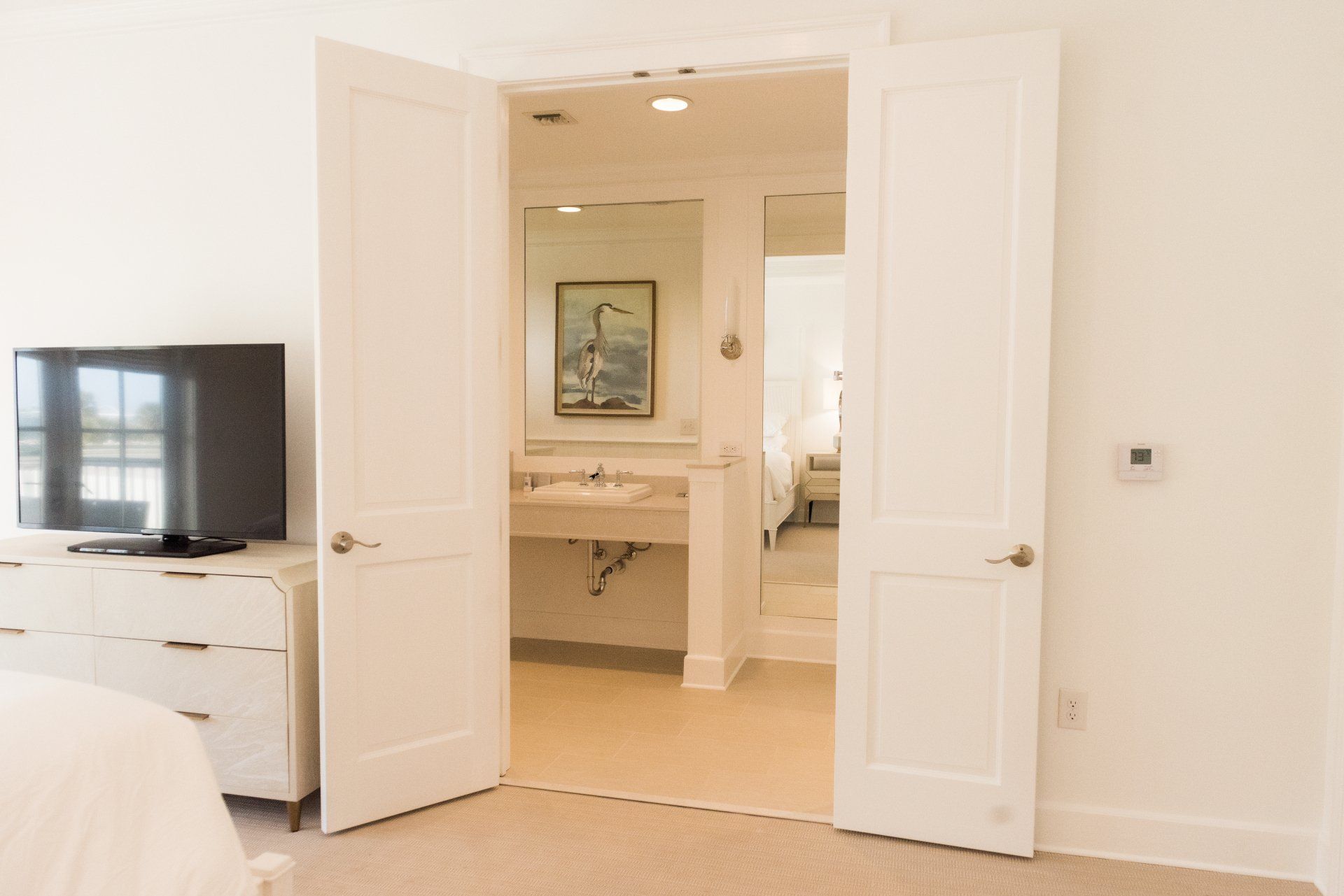 A bedroom with a television and a bathroom