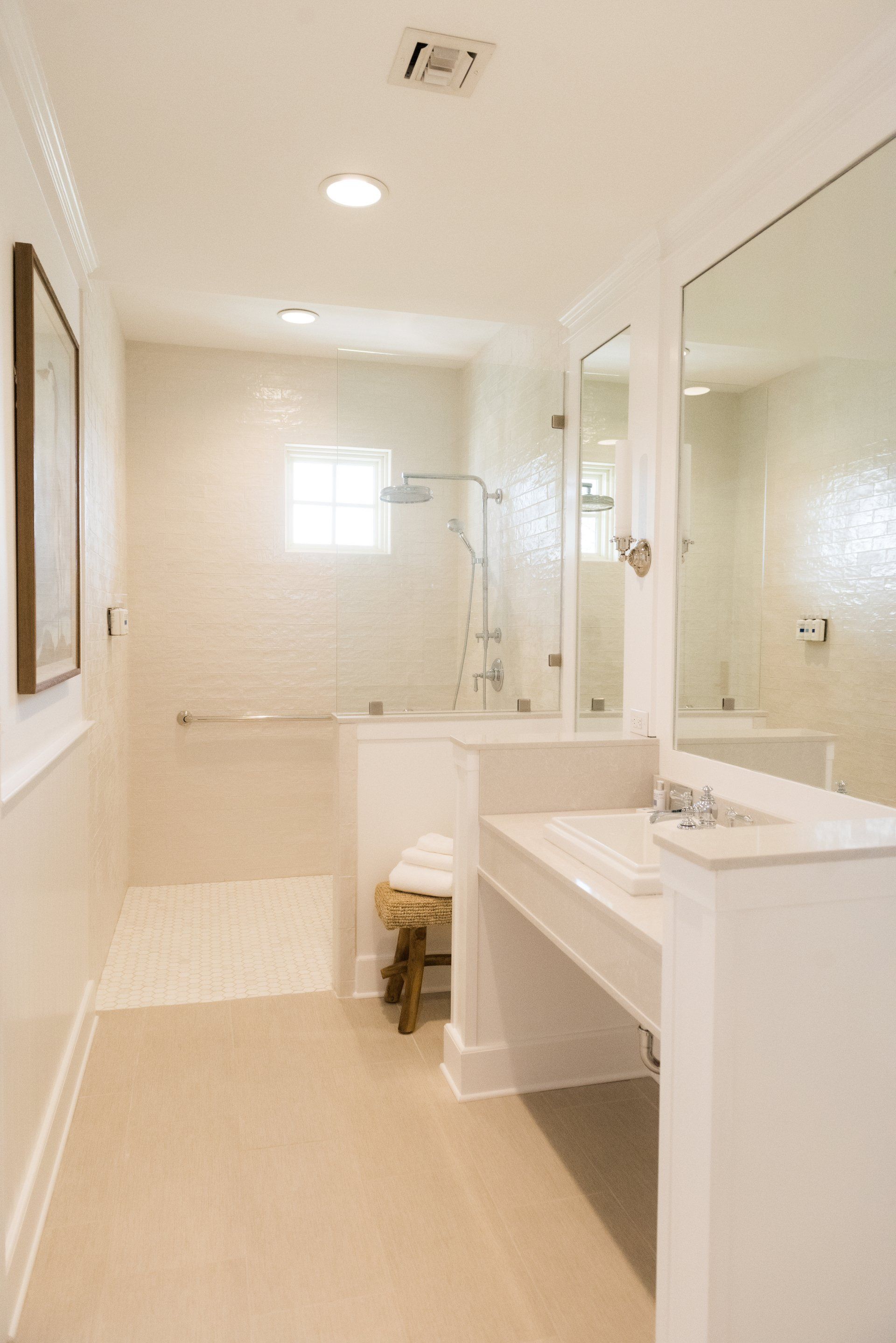 A bathroom with two sinks and a walk in shower