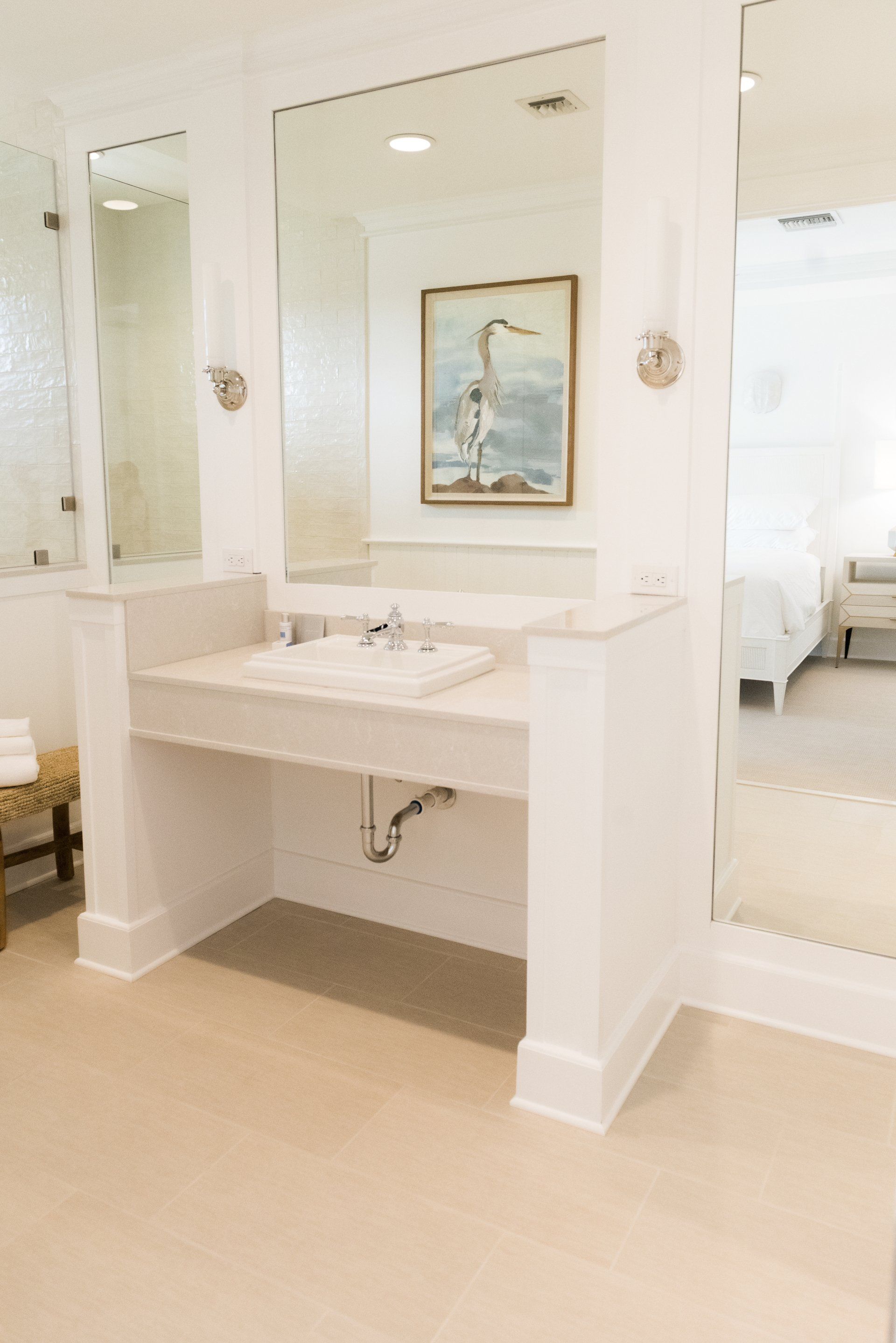 A bathroom with a sink and a large mirror