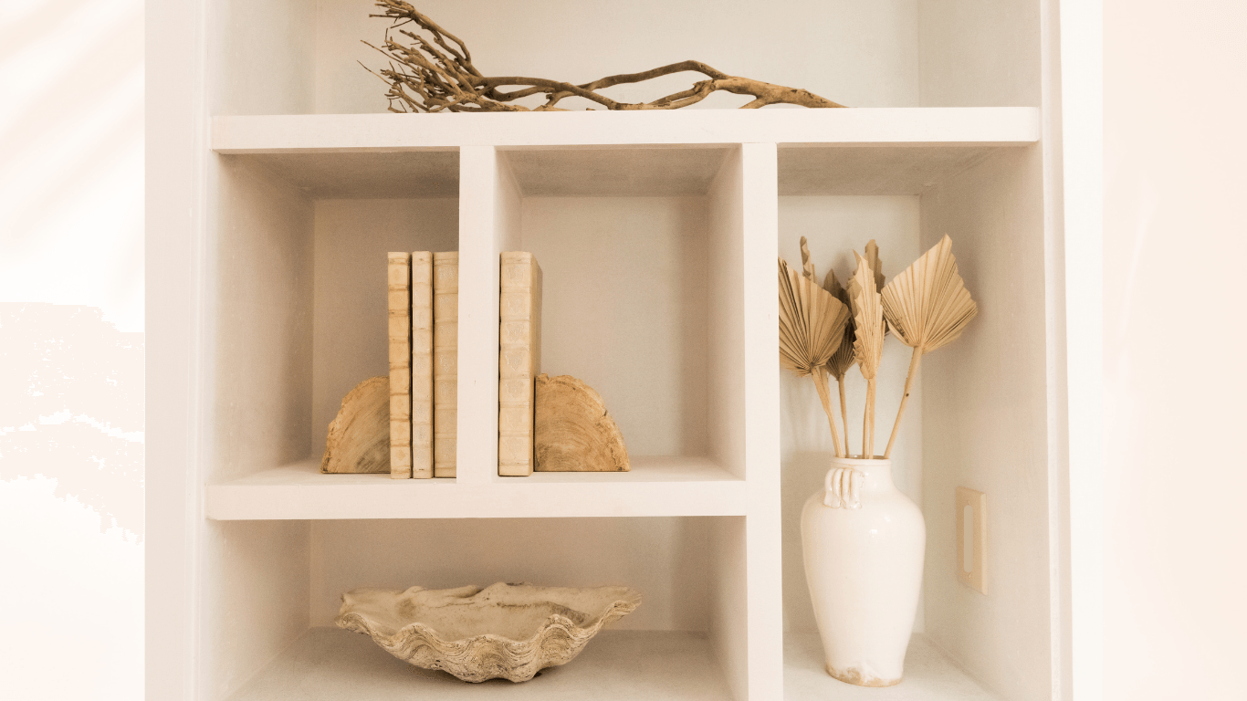 A bookshelf with a vase of flowers and books on it