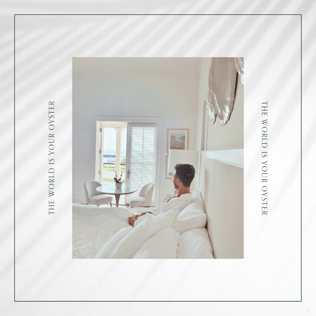 A man is laying on a bed in a hotel room