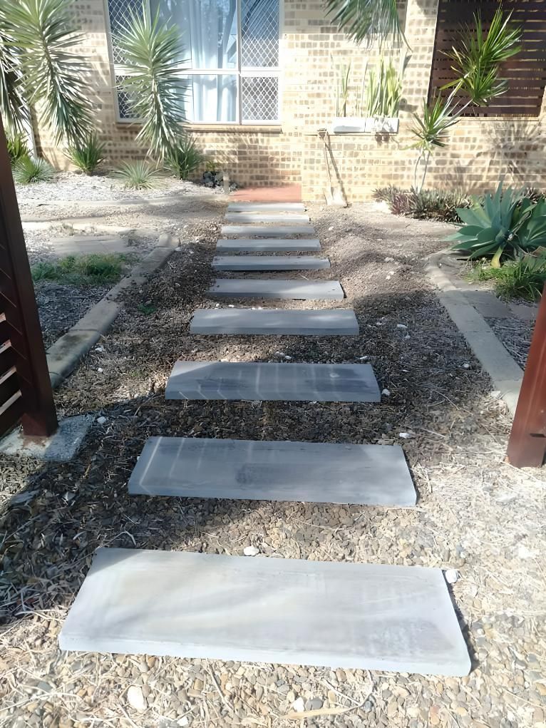 A Concrete Walkway Leading to a Brick House — Handyman Bundaberg In Burnett Heads, QLD