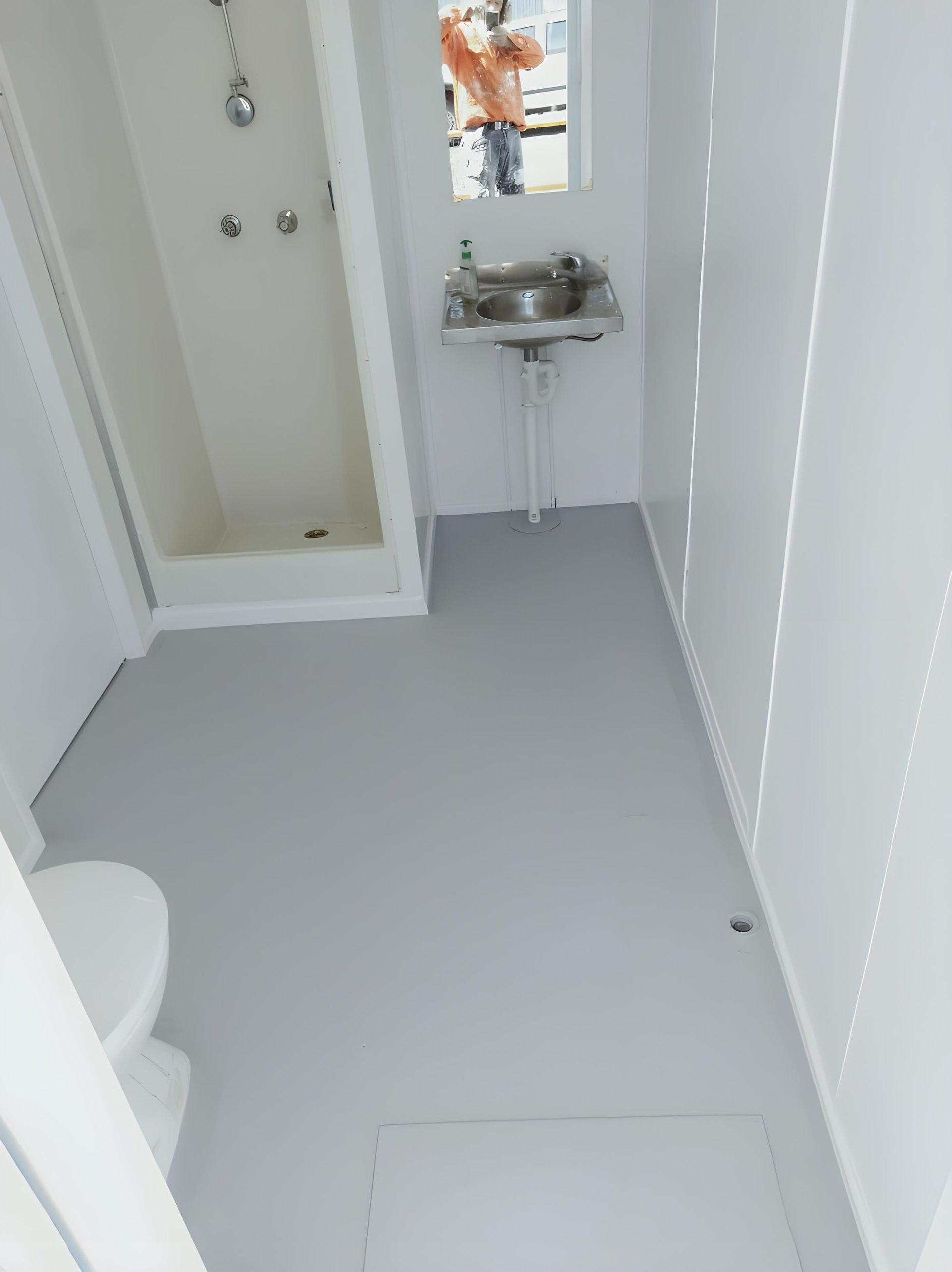 A Newly Painted Bathroom With a Toilet a Sink and a Shower  — Handyman Bundaberg In Burnett Heads, QLD