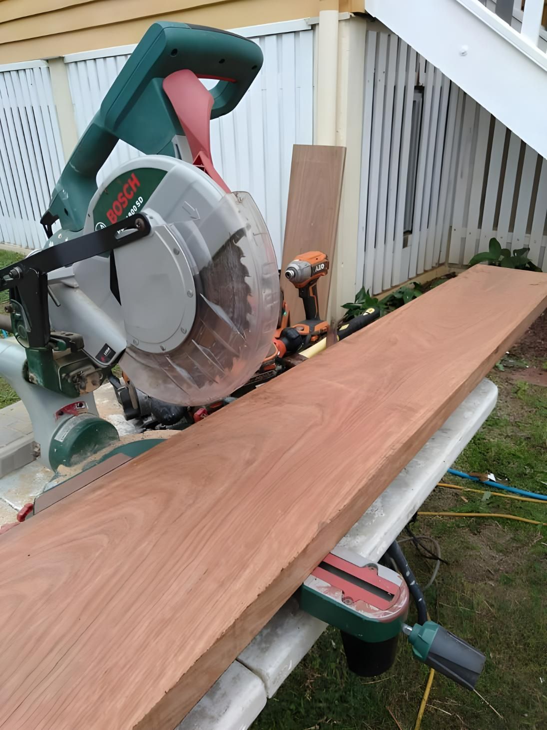 A Circular Saw is Cutting a Piece of Wood on a Table — Handyman Bundaberg In Burnett Heads, QLD