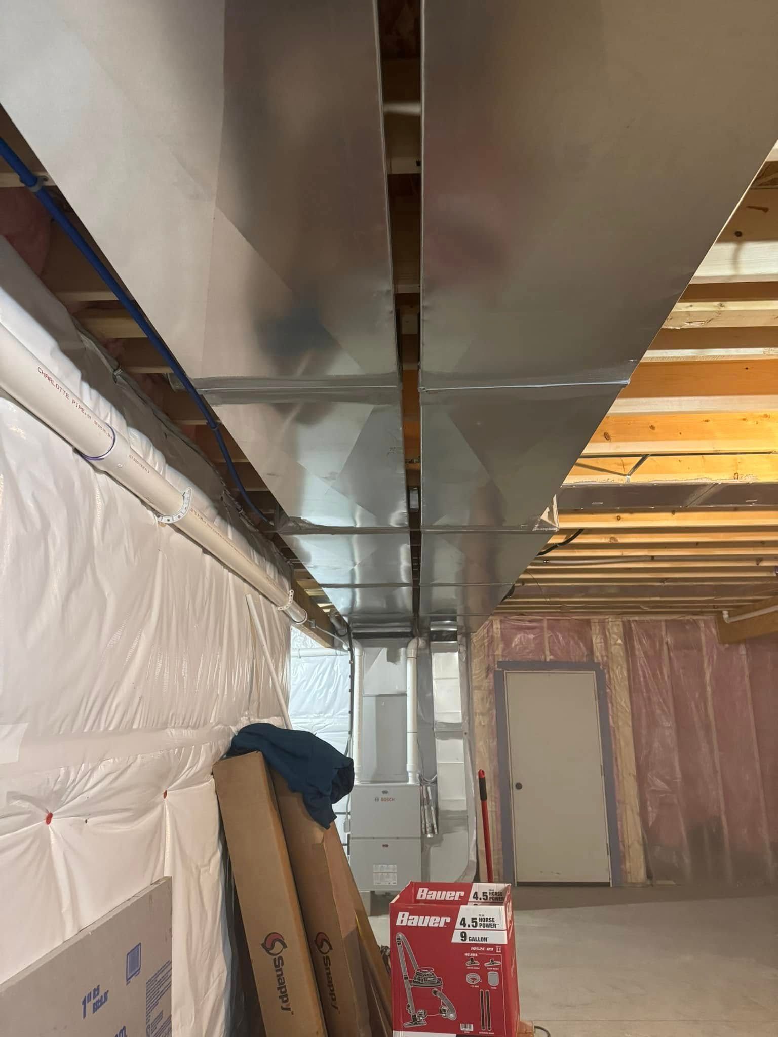 A room with a ceiling that is being built and a box on the floor.