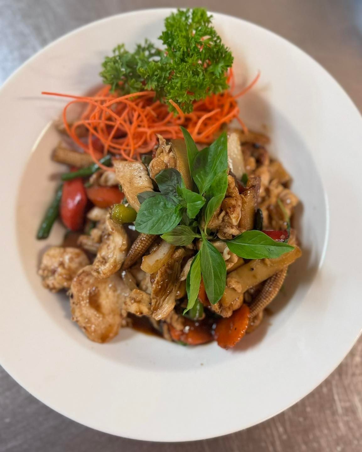 Thai Stir-fry With Chicken, Vegetables, and Basil in a White Bowl — Thai Taste Restaurant in Yeppoon, QLD