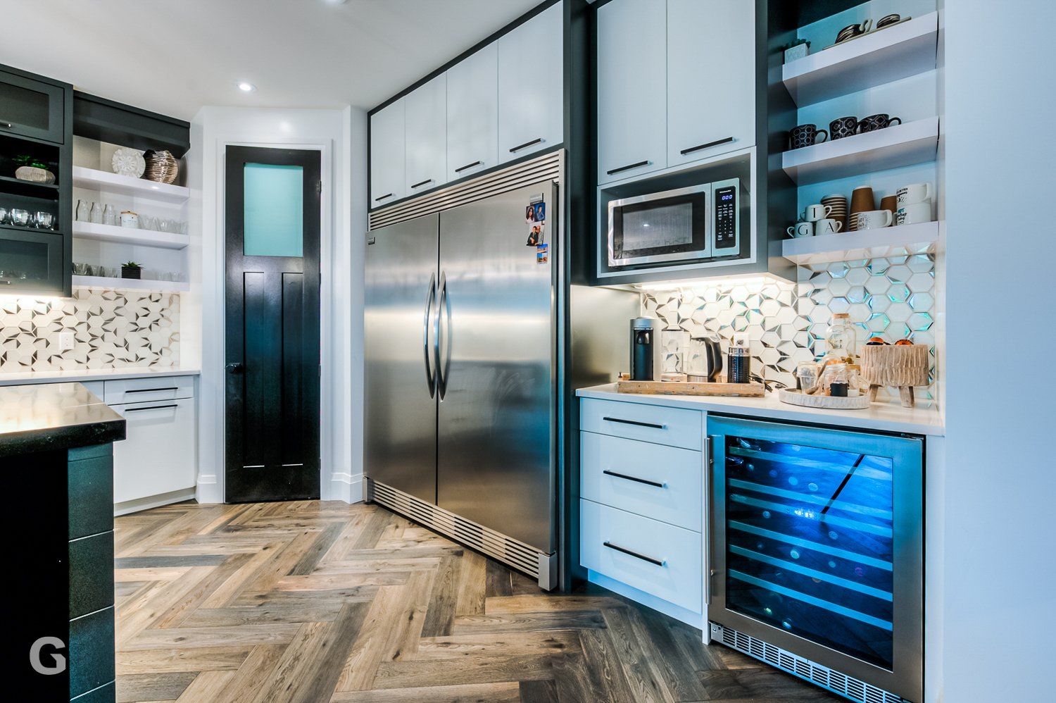 A kitchen with stainless steel appliances and a wine cooler.