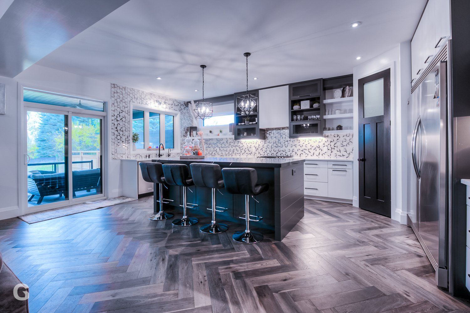 A large kitchen with a large island and stools.