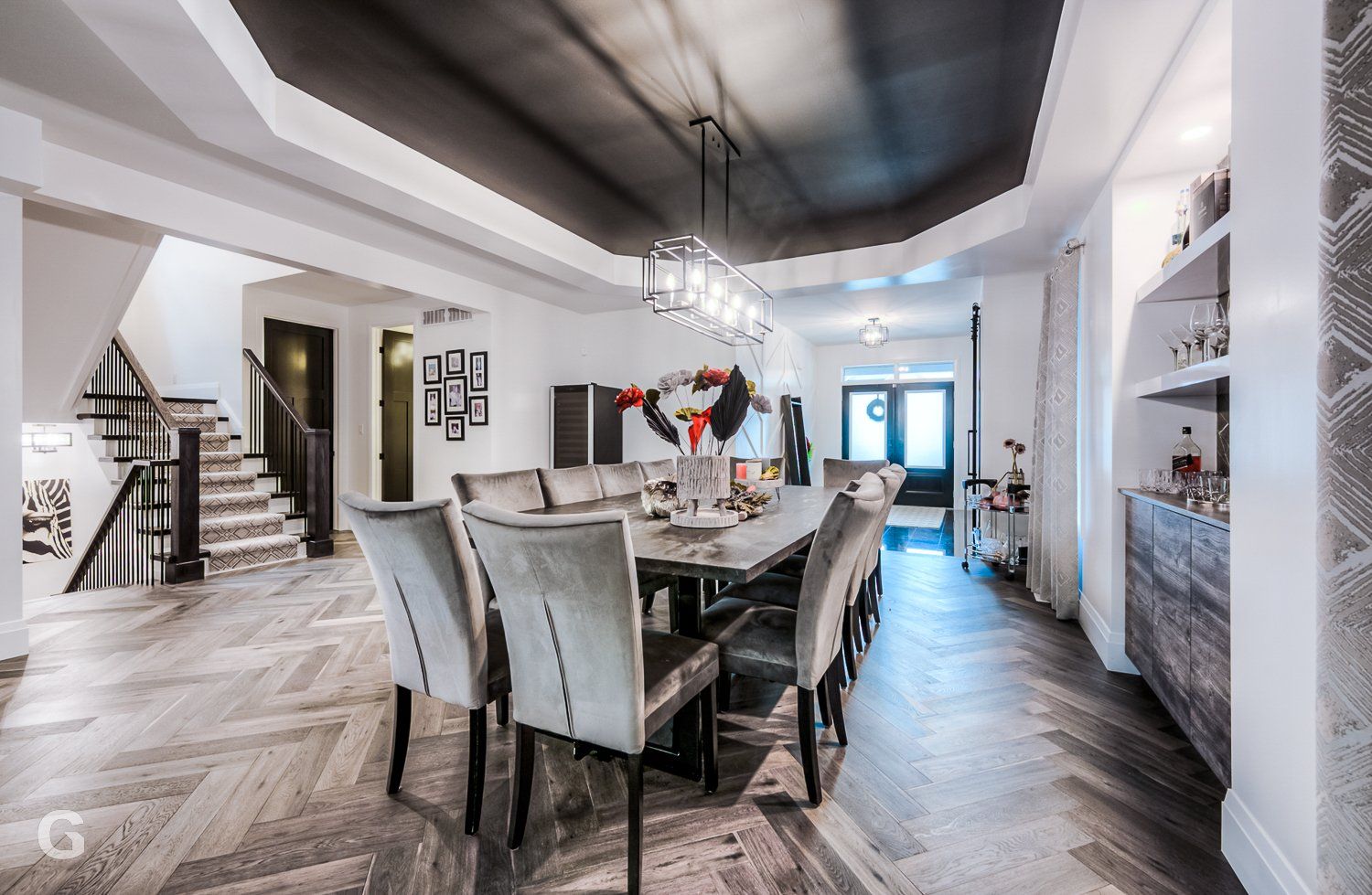 A large dining room with a long table and chairs.