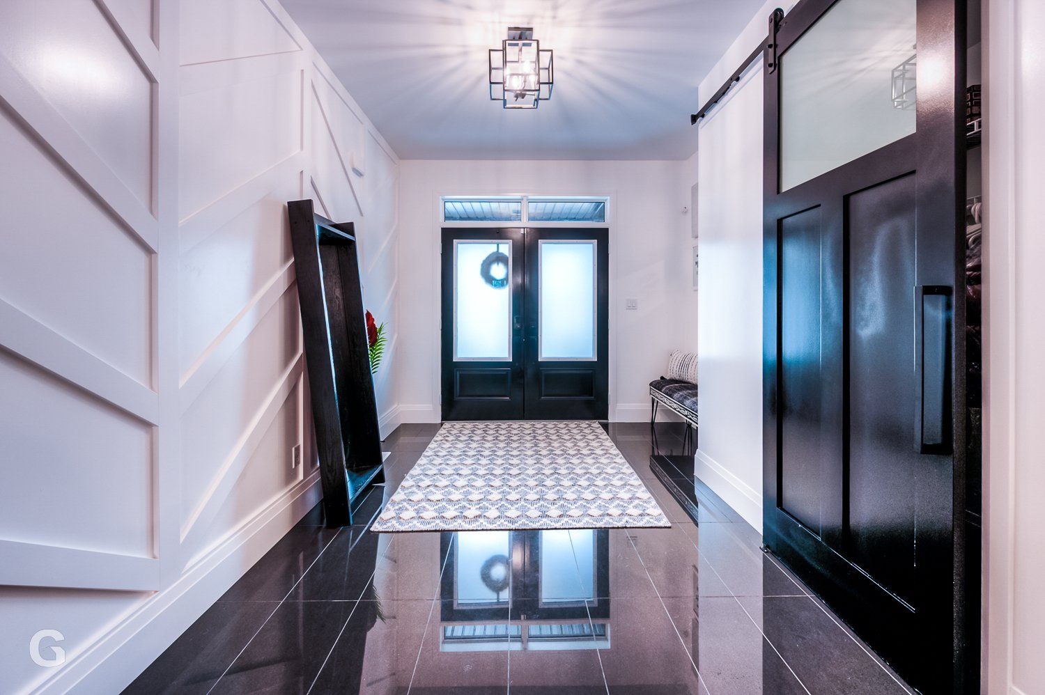 A hallway with black doors and white walls