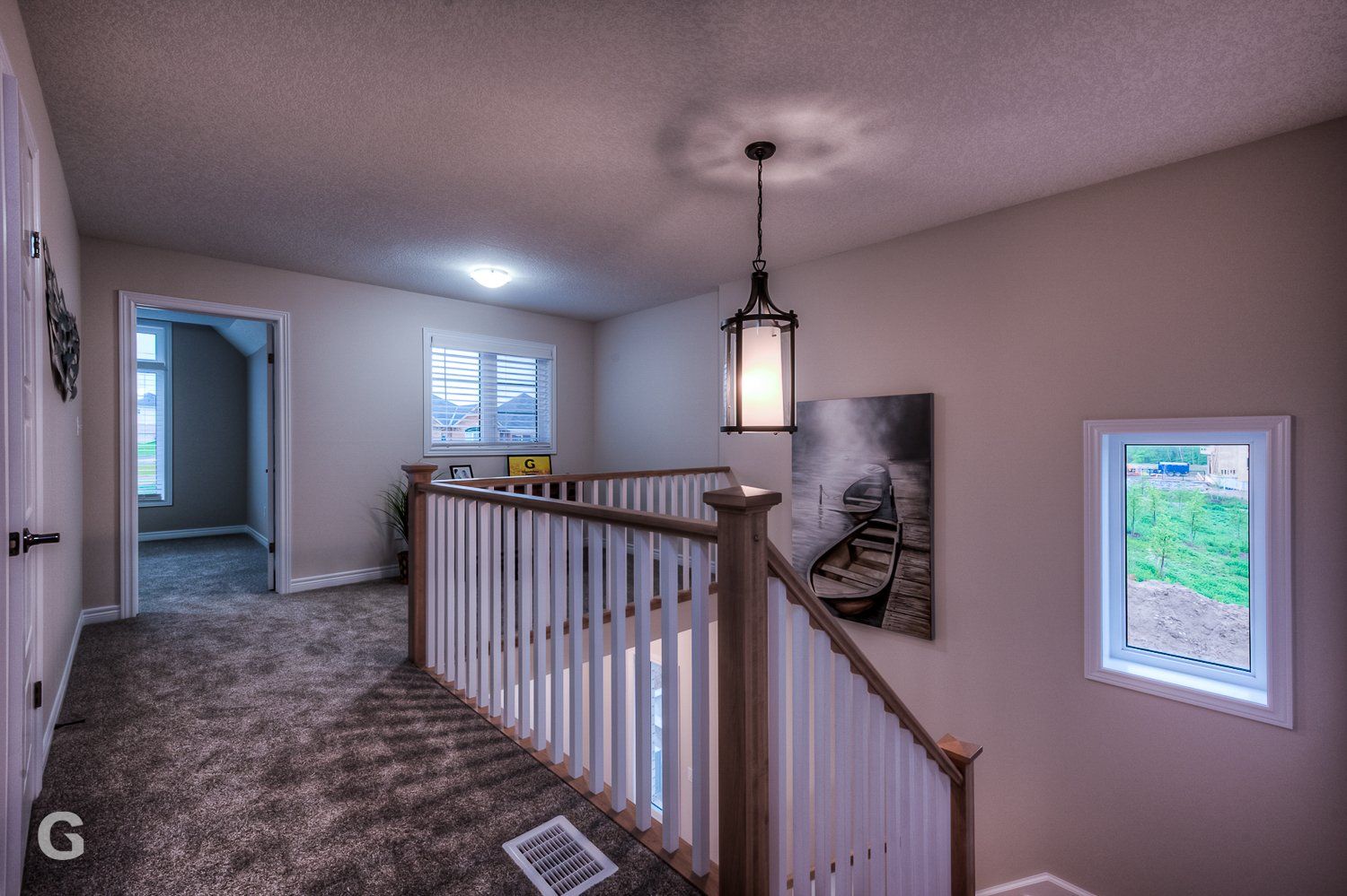 A staircase in a house with a painting on the wall
