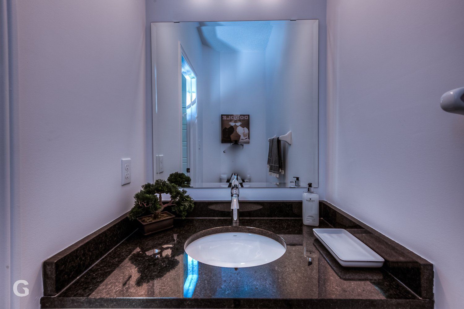 A bathroom with a sink and a large mirror