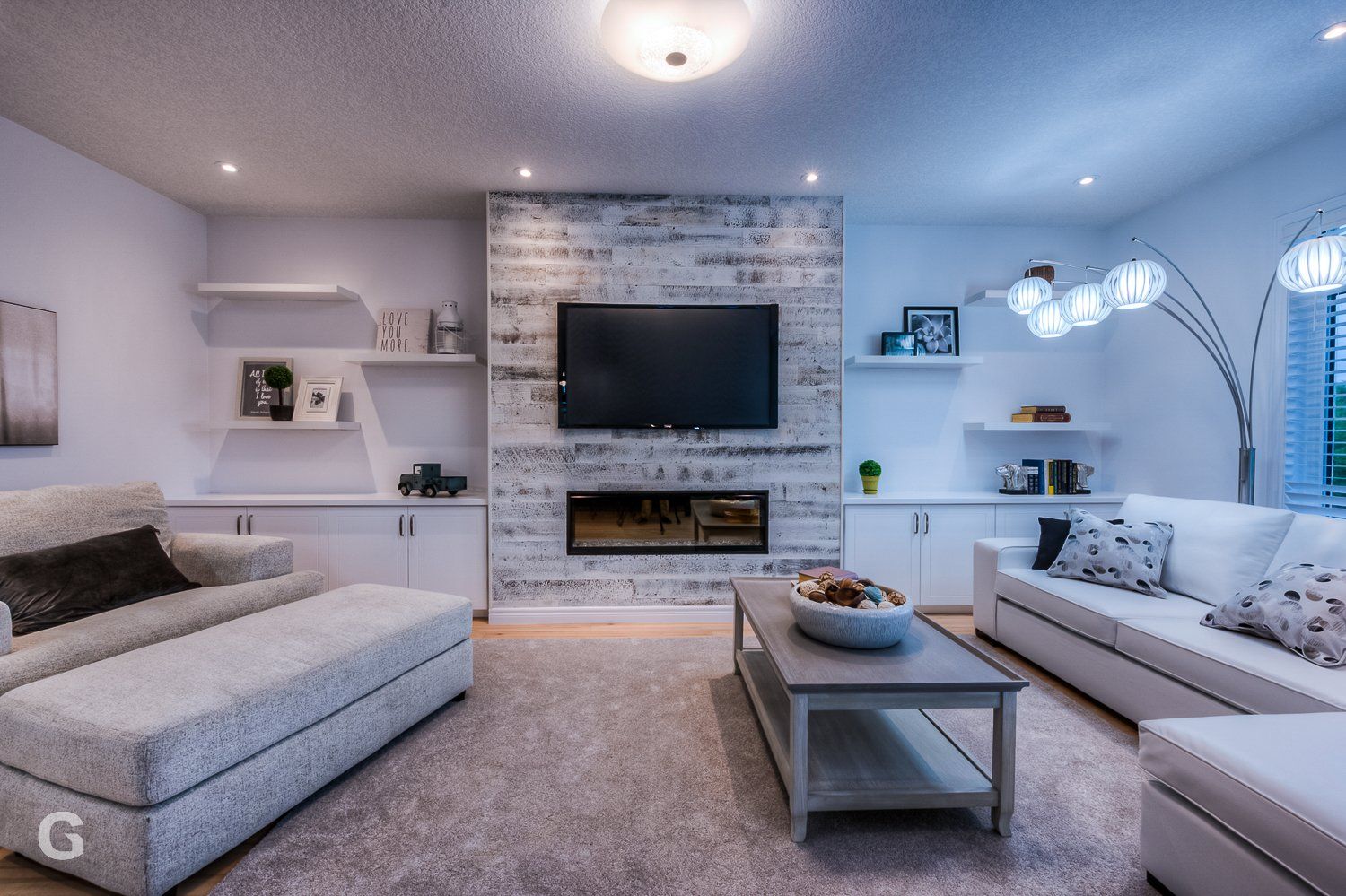 A living room with a fireplace and a flat screen tv