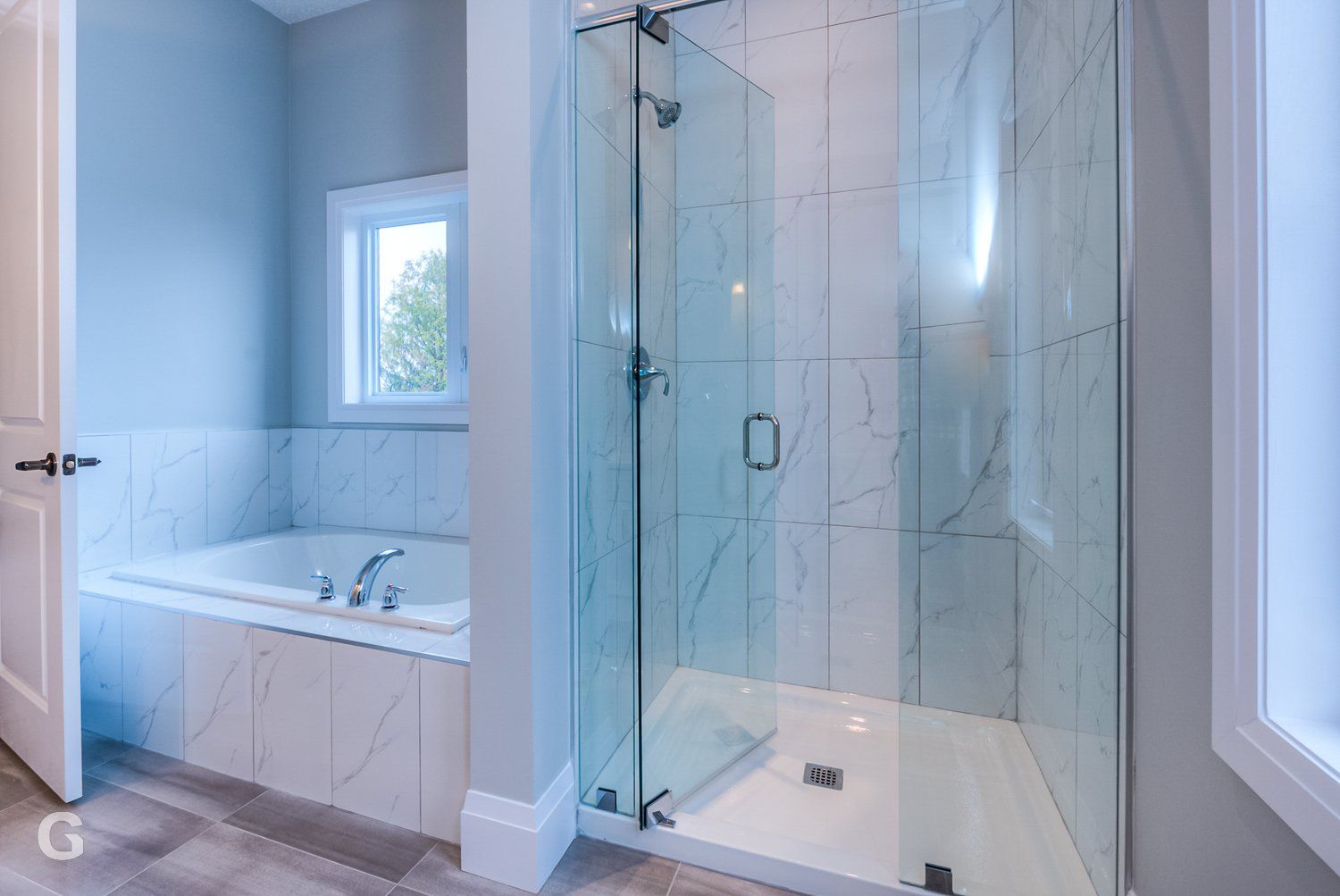 A bathroom with a walk in shower , tub , and window.
