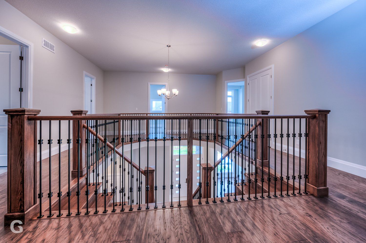 A staircase in a house with a wooden railing