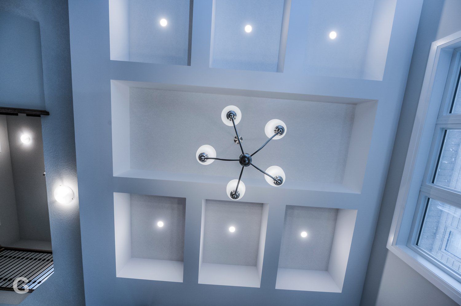 A chandelier is hanging from the ceiling of a room.