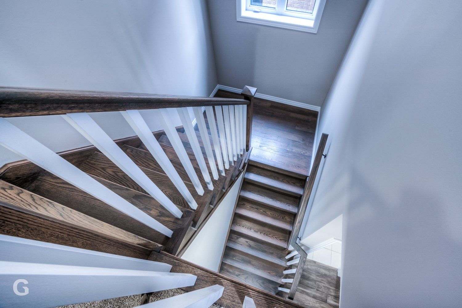 The stairs are made of wood and have a white railing.