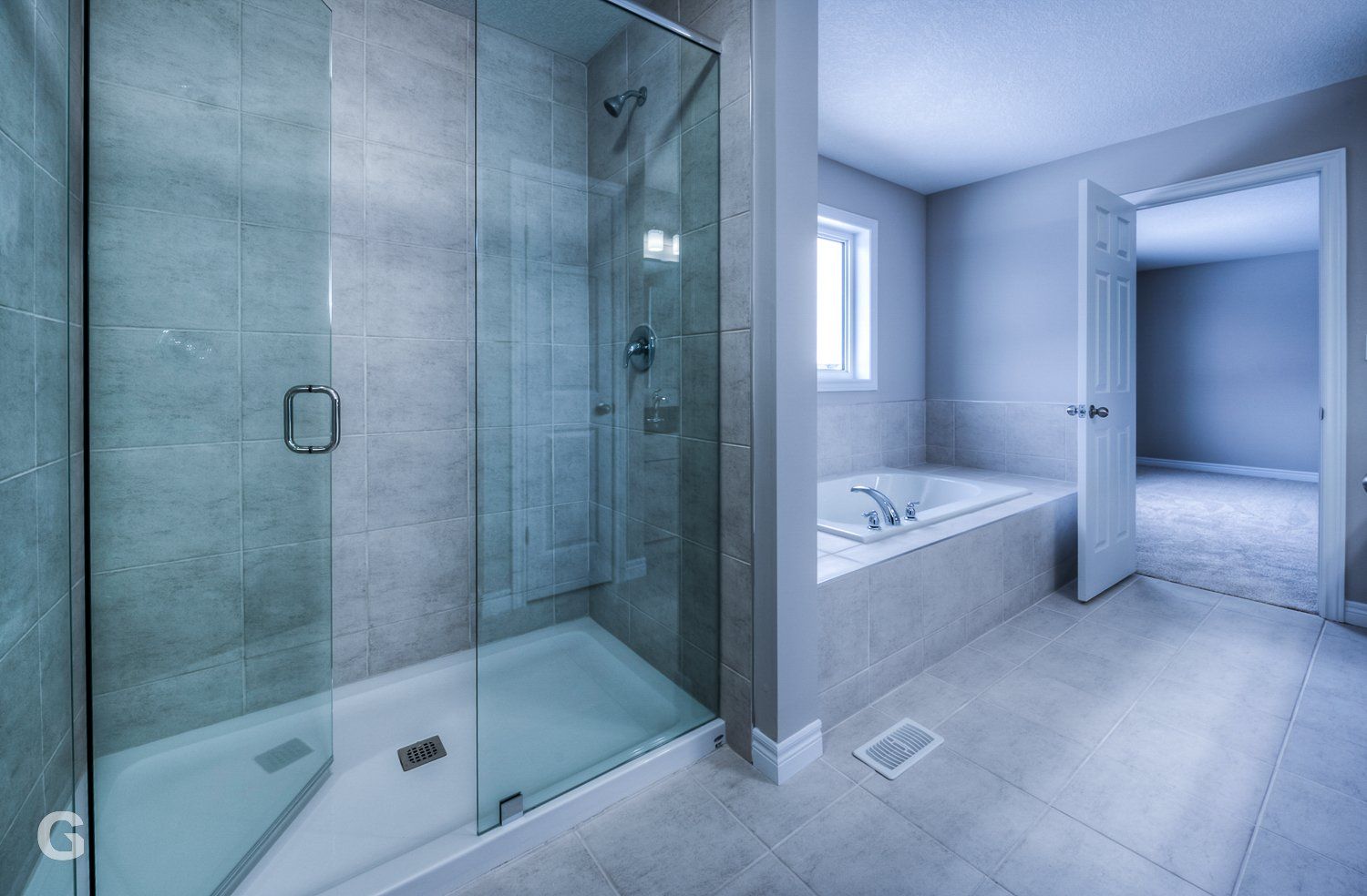 A bathroom with a walk in shower and a bathtub