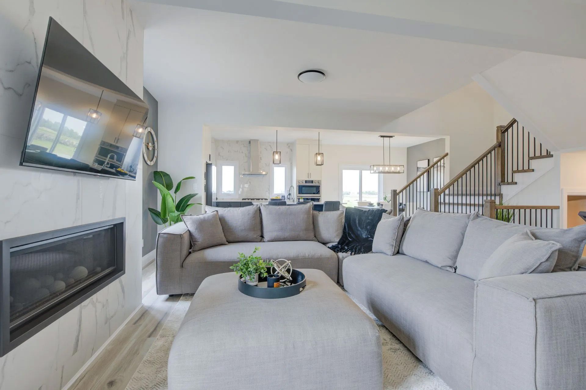 A living room with a couch , coffee table , television and fireplace.