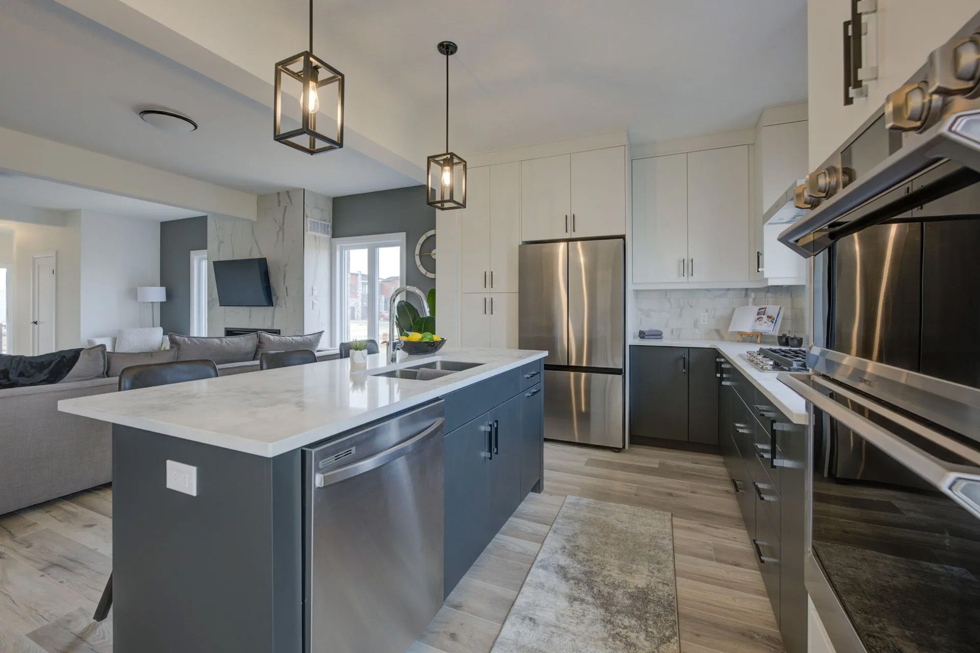 A kitchen with stainless steel appliances and a large island.