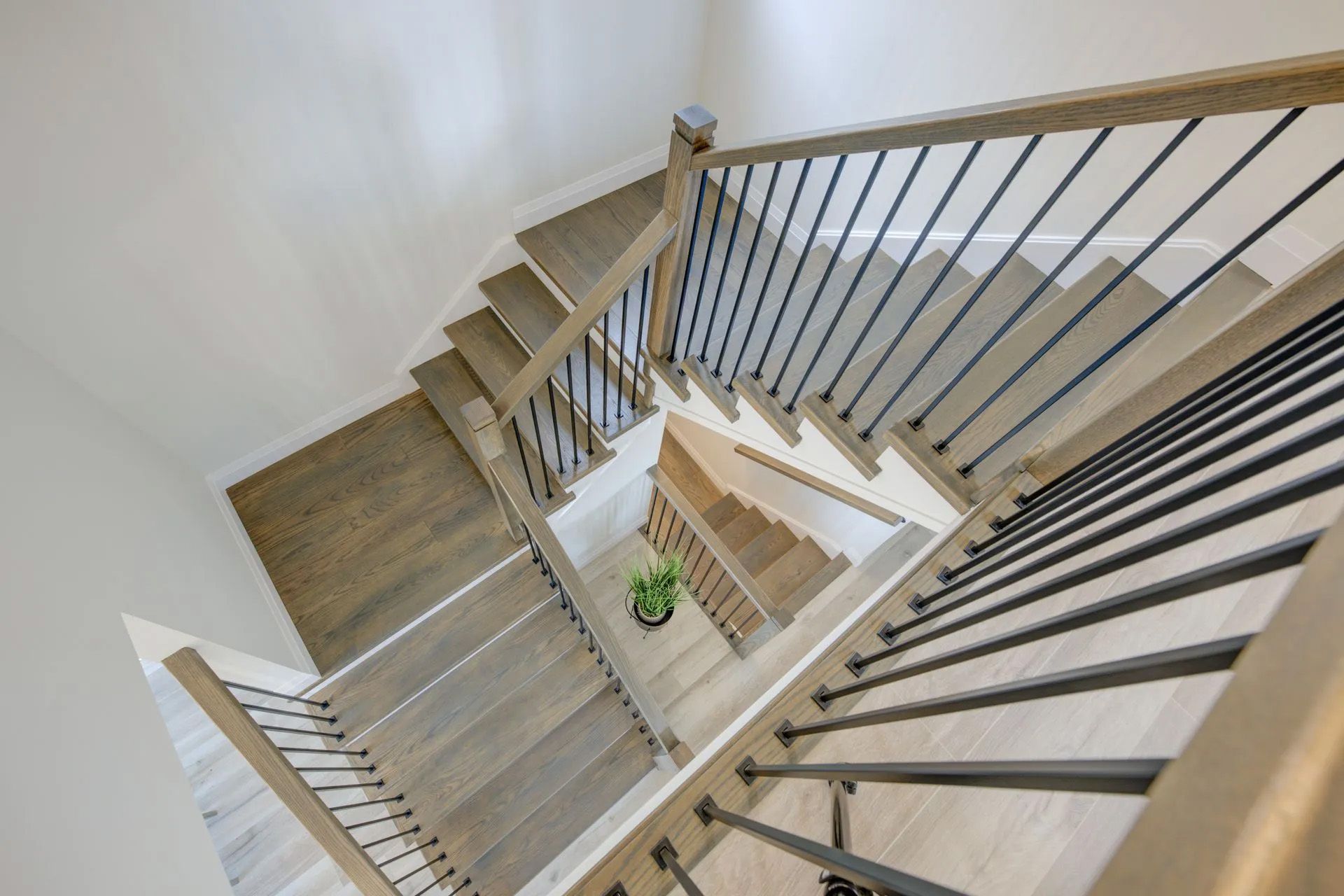 The stairs are made of wood and metal and have a metal railing.