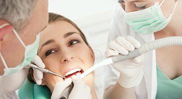 dentist and dental assistant with patient