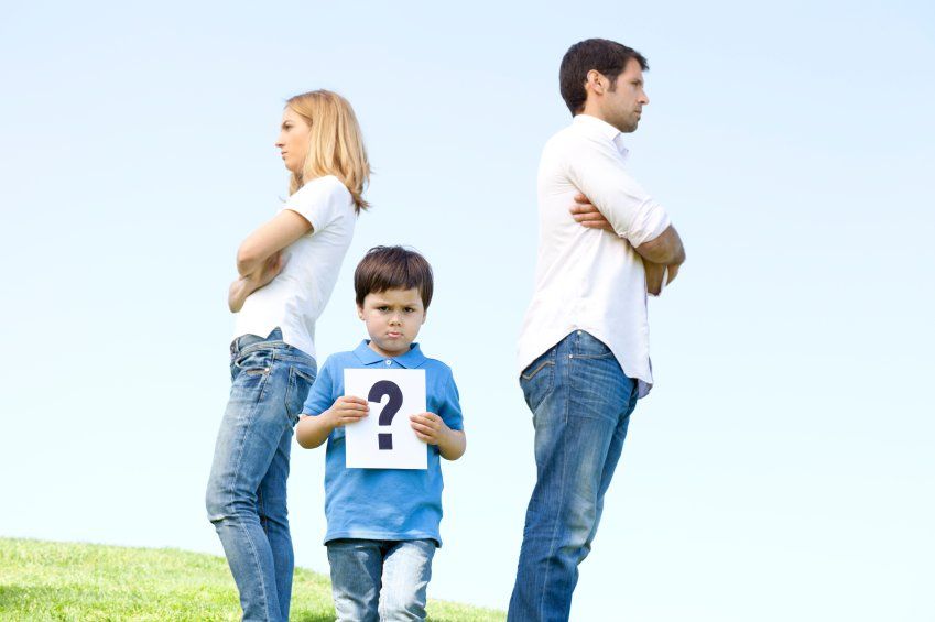 Couple standing in opposite direction with a kid standing in middle