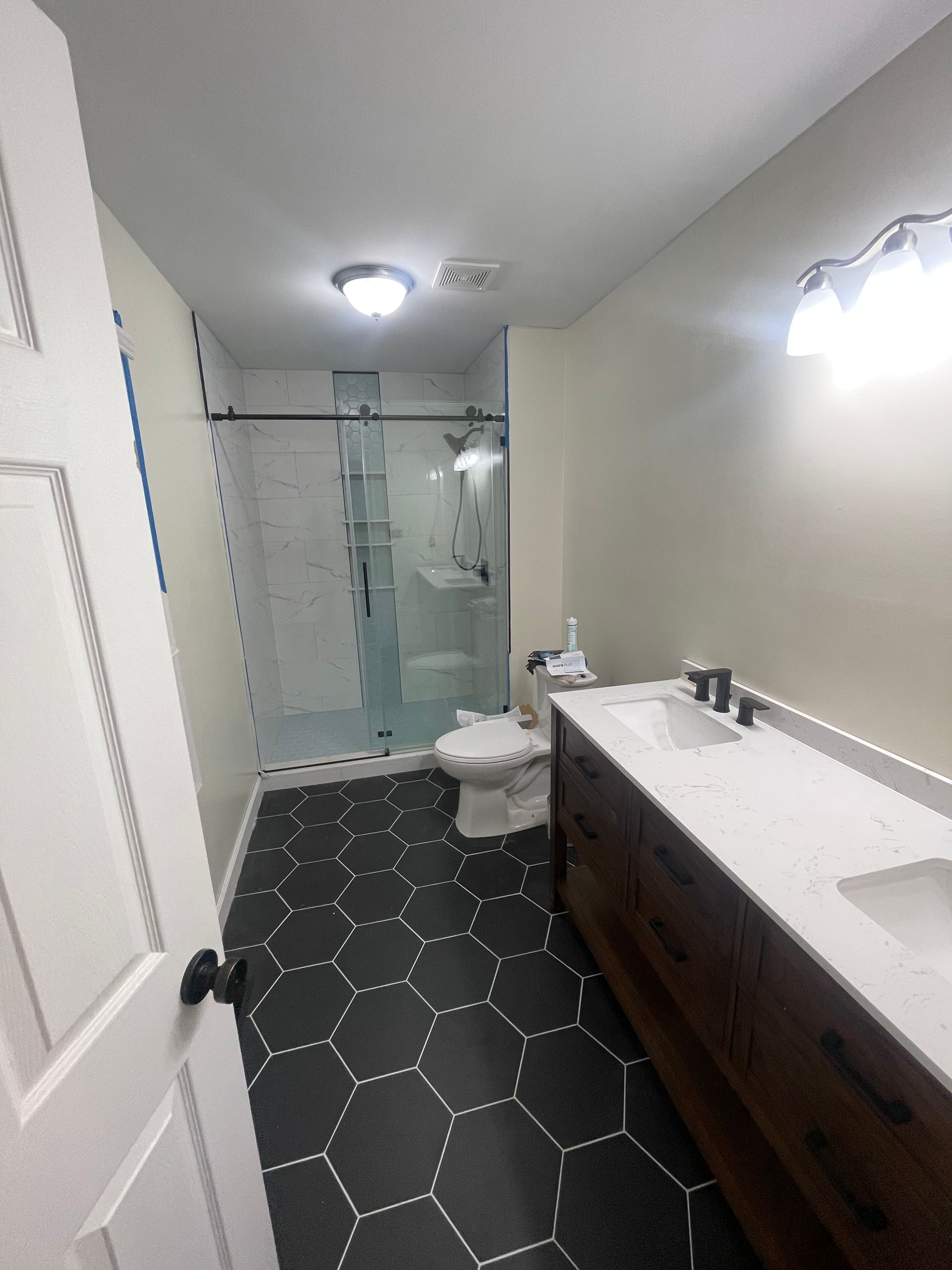 shower fixture installation, toilet replacement, vanity installation, bathroom countertops, shower tile, grout, waterproofing