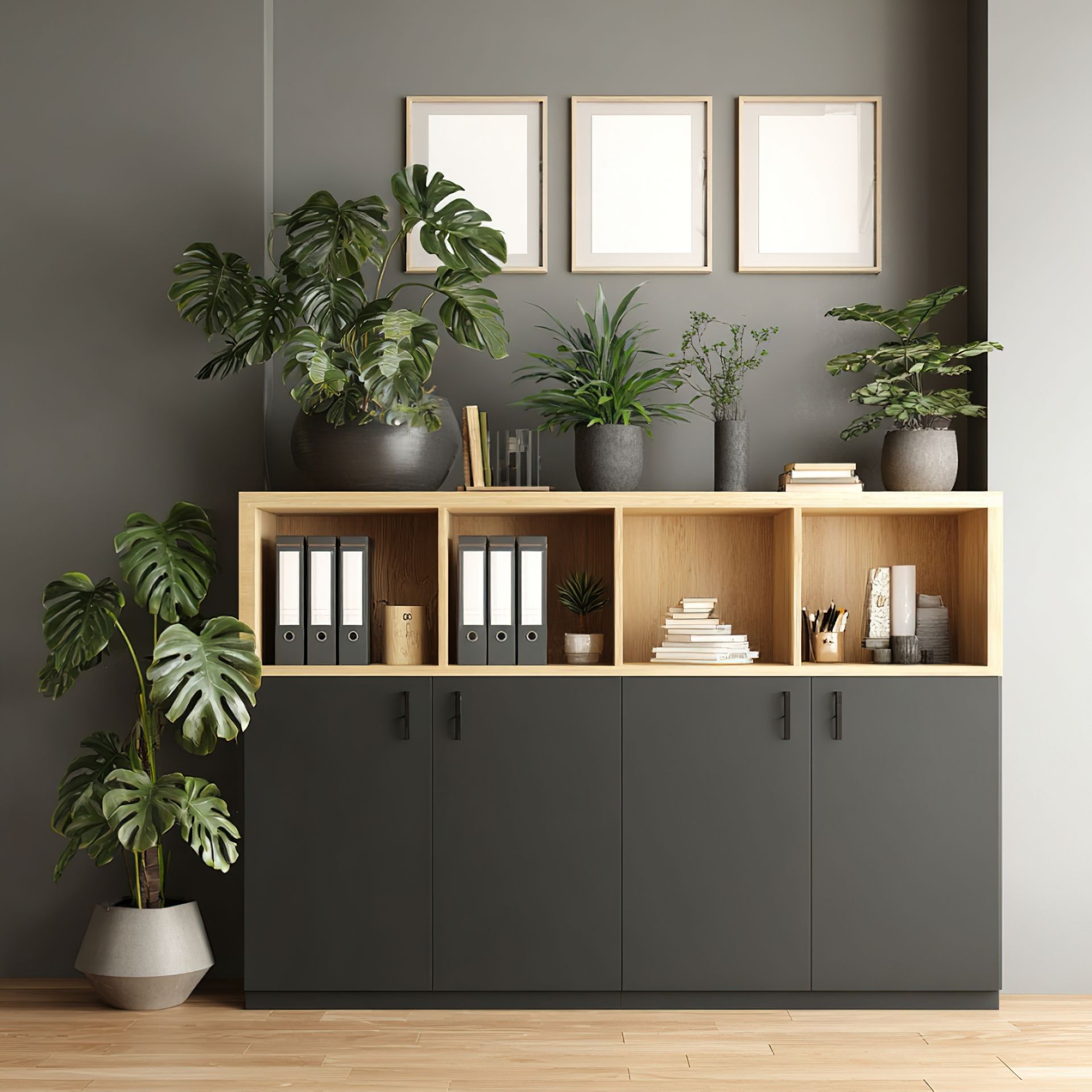 Office storage cabinet with open shelving, dark gray base, and wooden accents, adorned with plants and framed artwork.