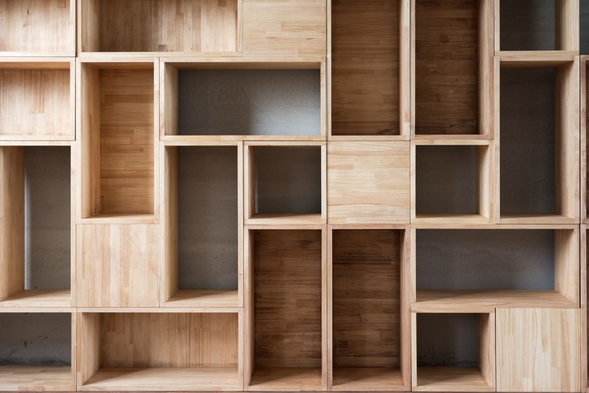 Wooden shelving unit with various rectangular compartments.