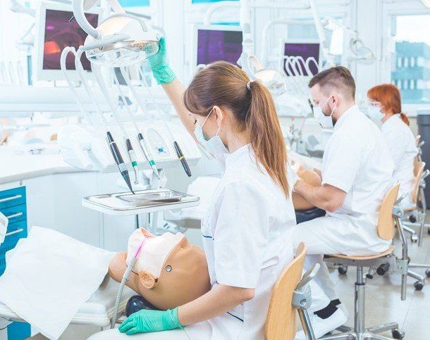 a group of dentists are working on a patient in a dental office .