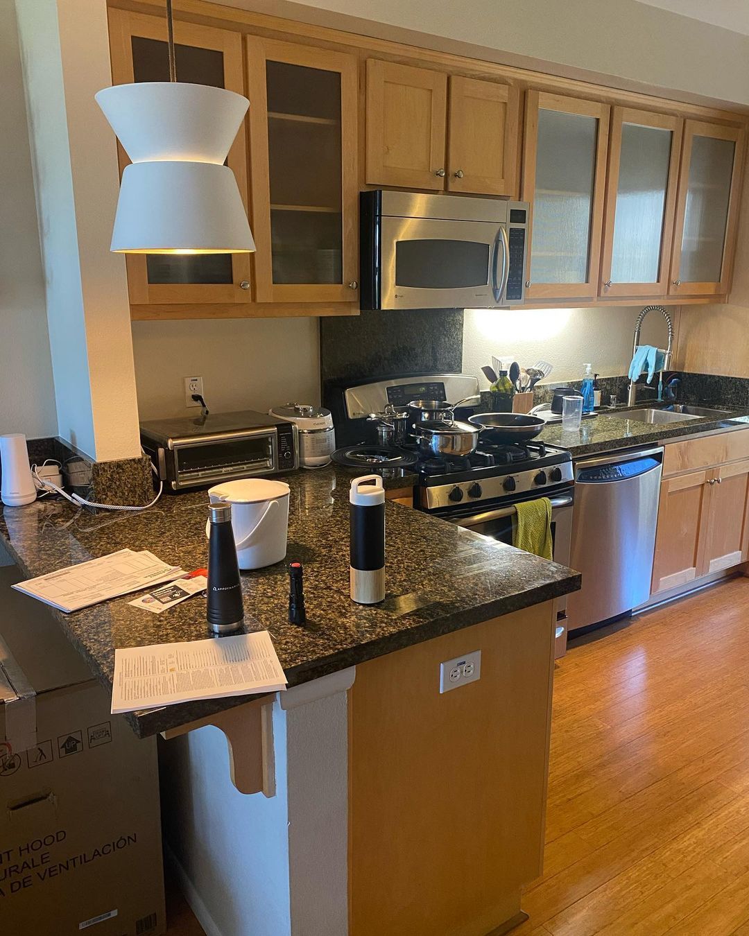 A kitchen with stainless steel appliances and granite counter tops
