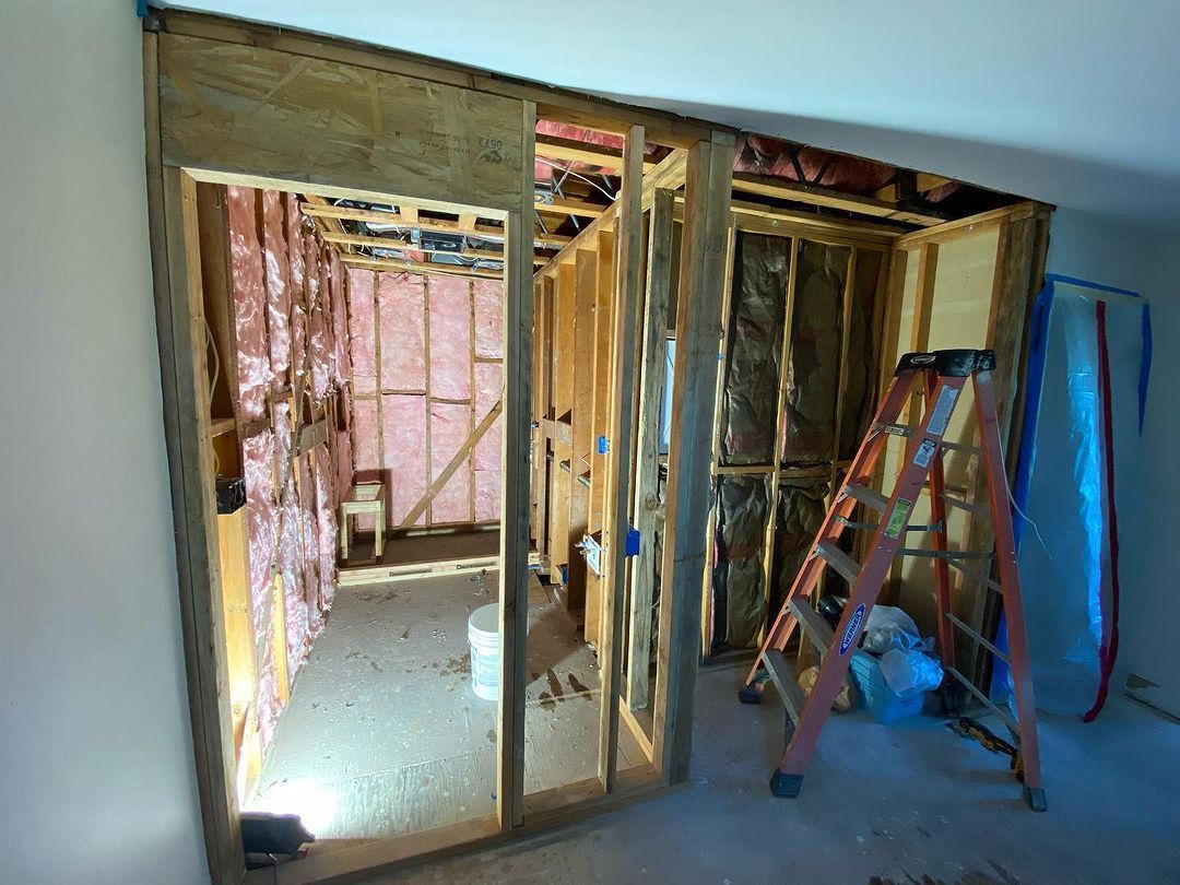 A room that is being remodeled with a ladder in it.