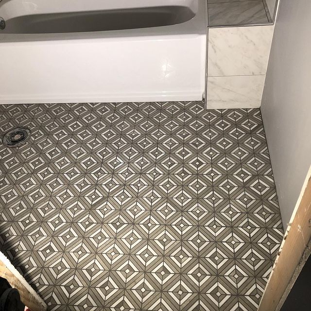 A bathroom with a bathtub and a tiled floor