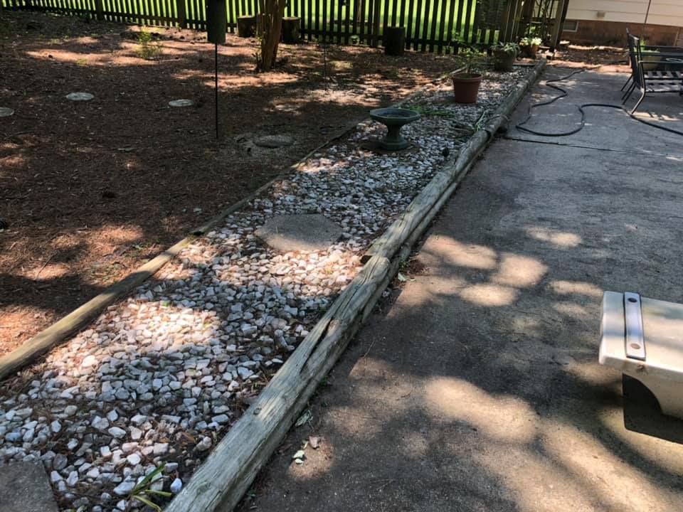 There is a bench in the middle of a gravel path.
