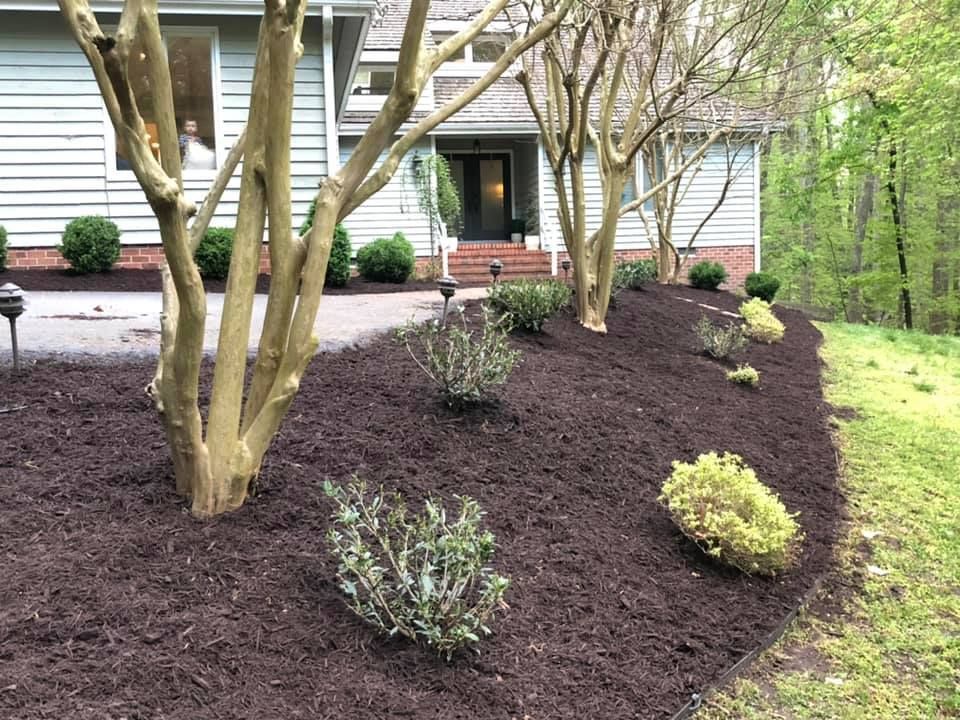 A house with a lot of mulch in front of it