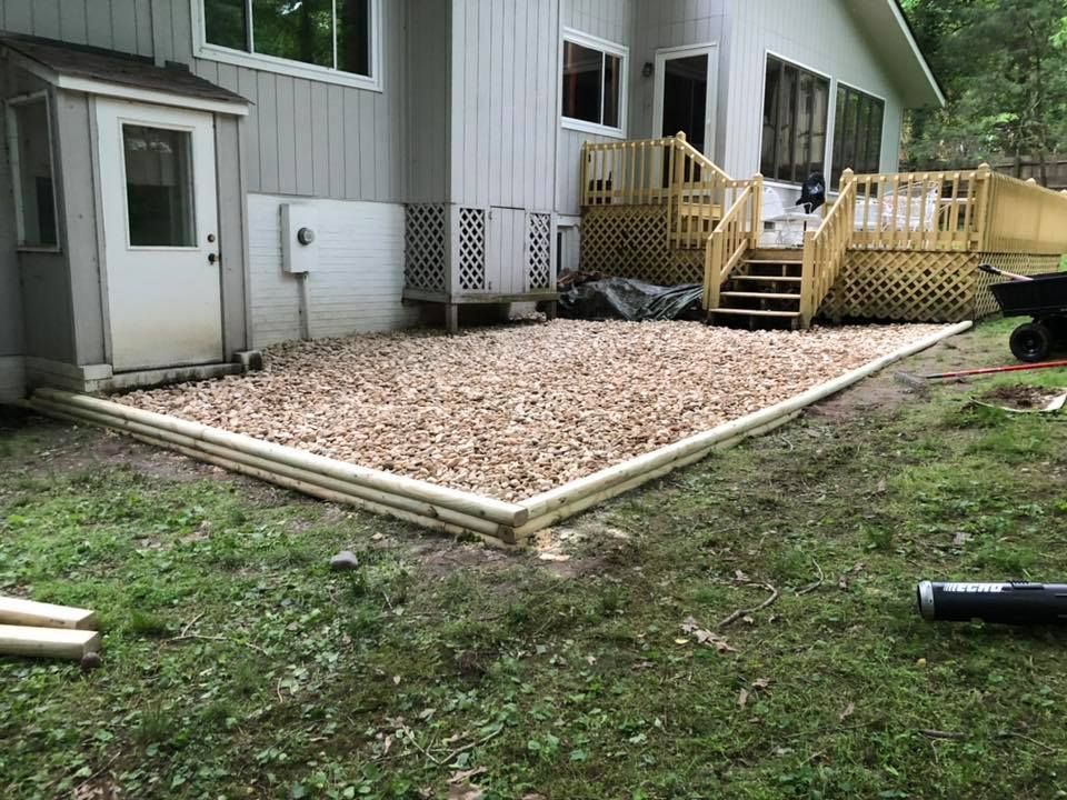 A house with a deck and stairs in the backyard.