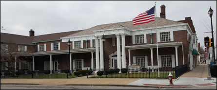 A funeral home with a sign in front of it