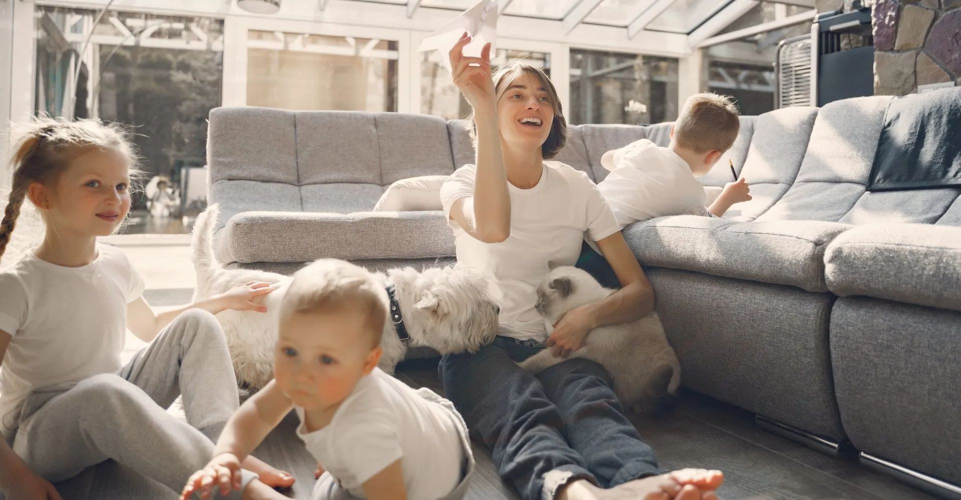 A family seated in a lounge area, with dogs.