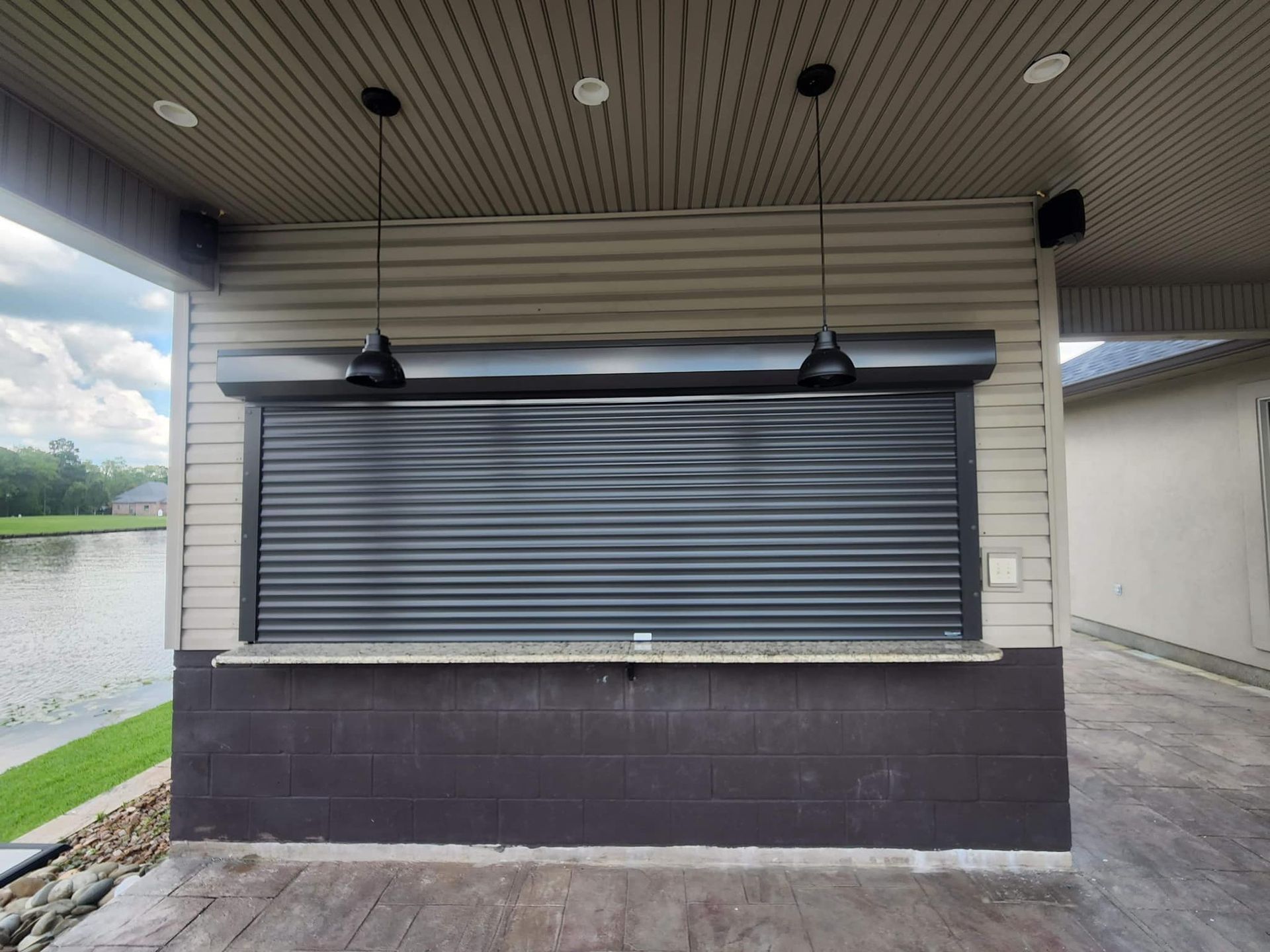 a building with a black shutter on the side of it .