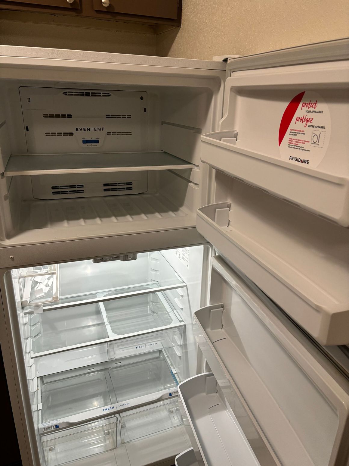 The inside of an empty refrigerator with the door open